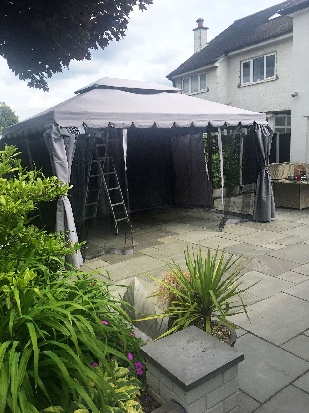 Fabric gazebo in the process of being erected.
