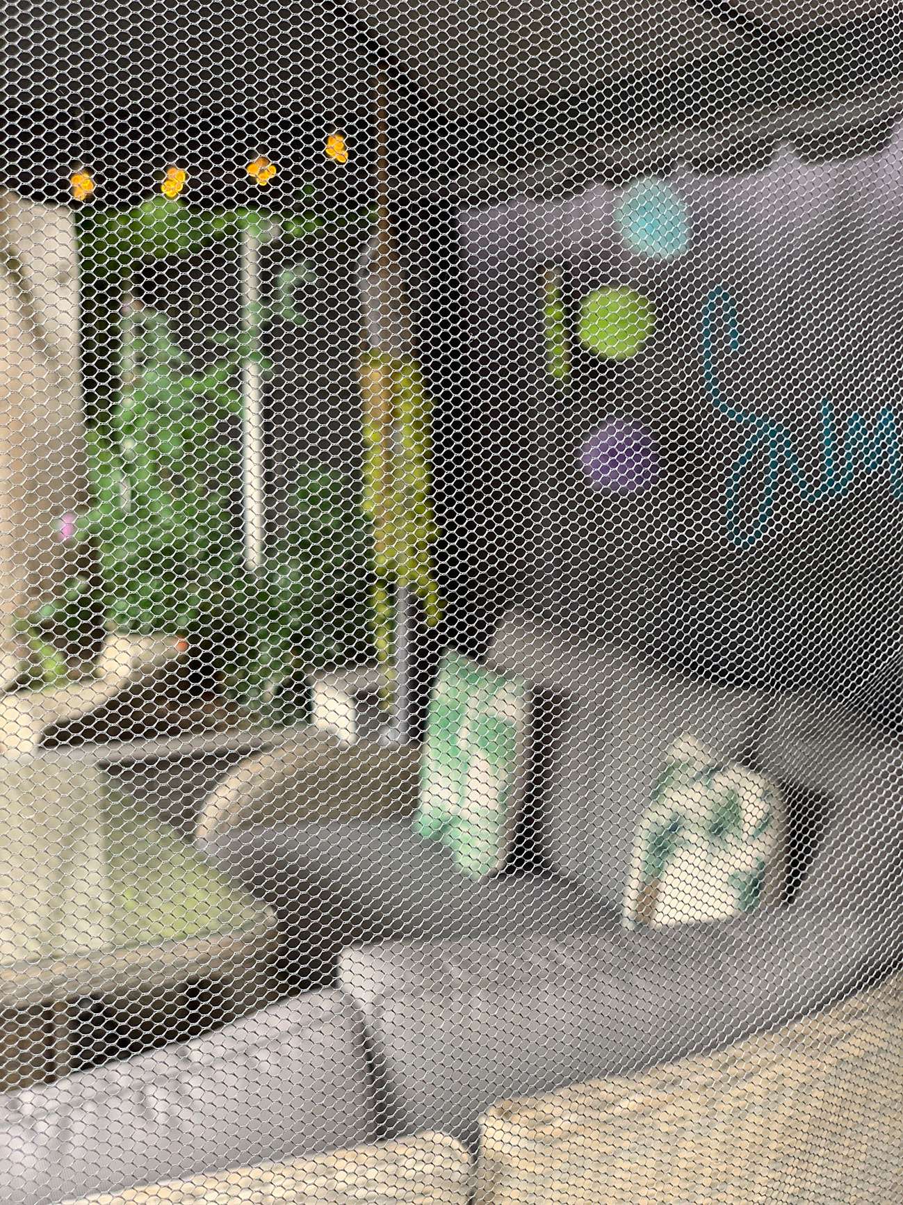 Gazebo fly screen covering patio seating and decoration.
