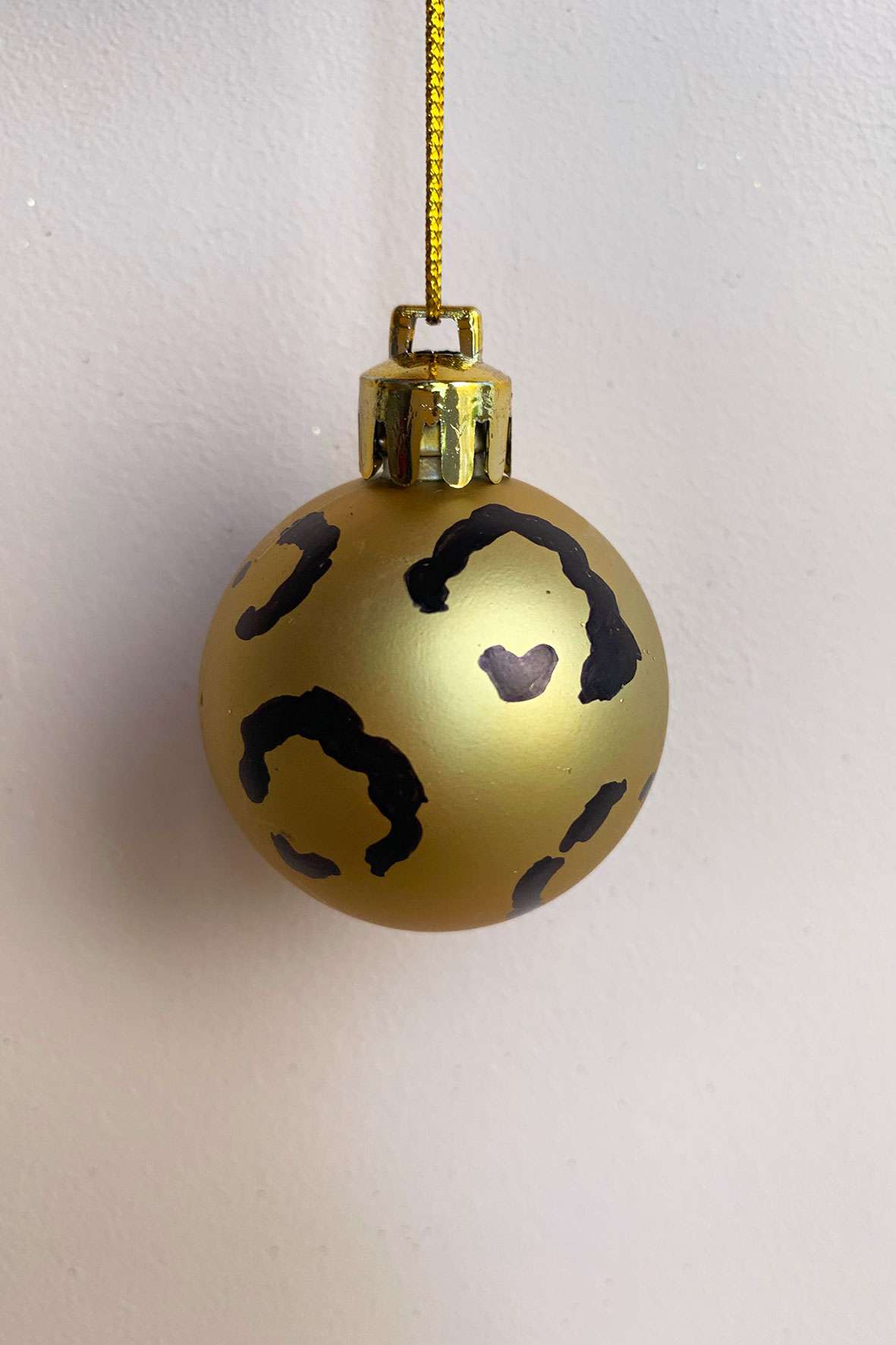 Gold Christmas bauble with a leopard print design