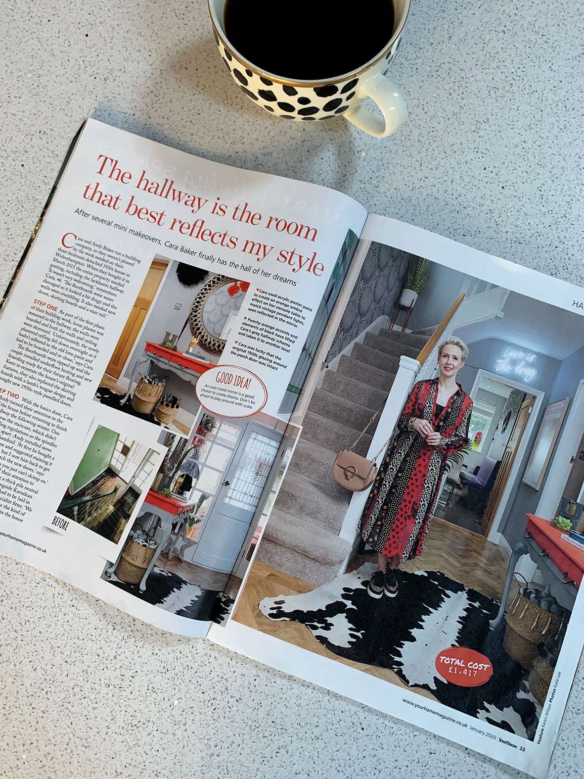 Interiors magazine opened at a page with hallway pictures and cup of coffee next to it.