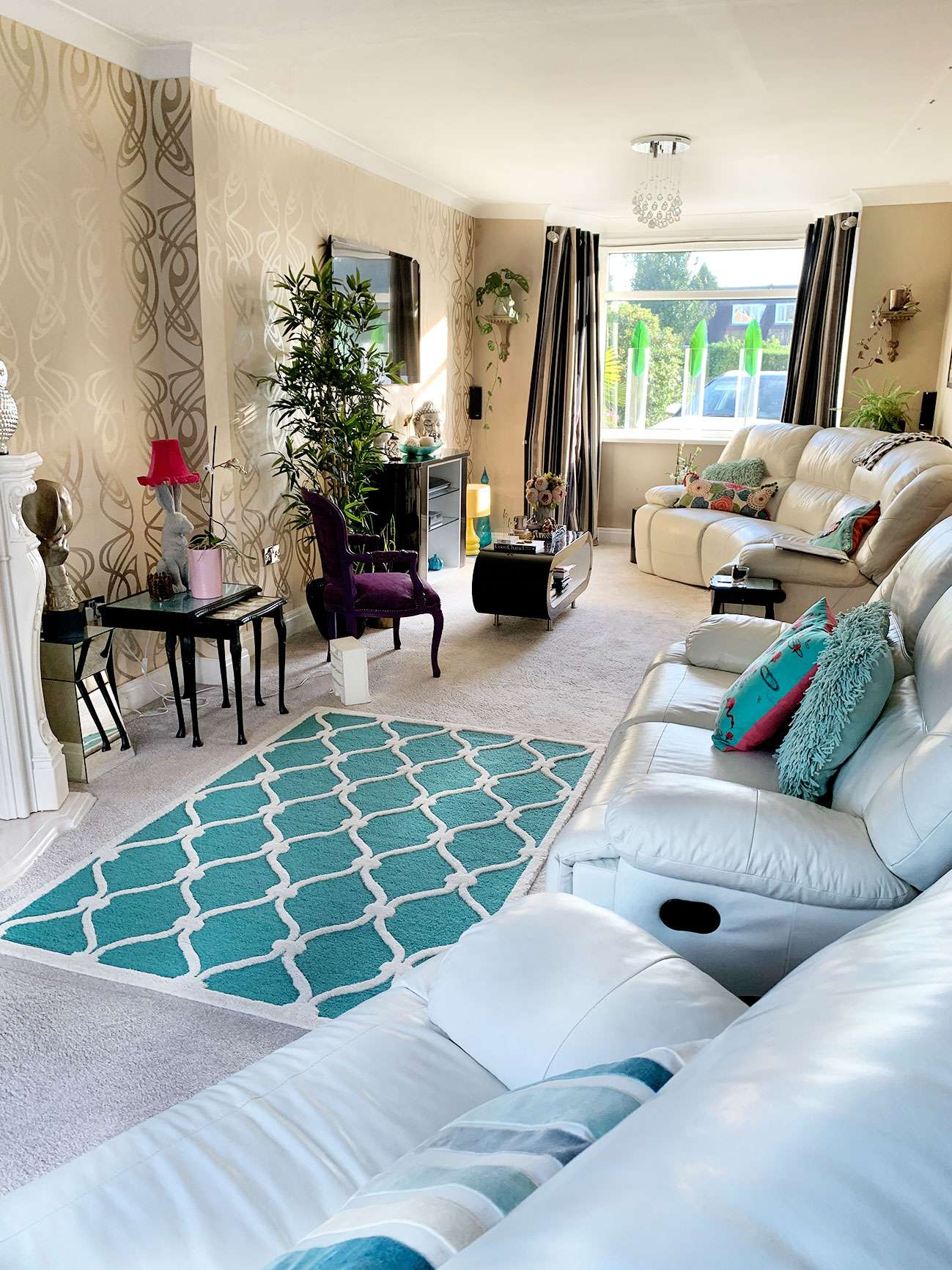 living room with beige carpet and sofa and black striped curtains