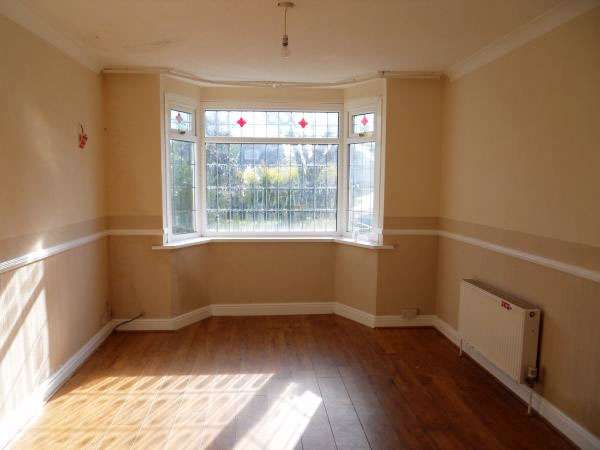 empty living room with dado rail and laminate floor.