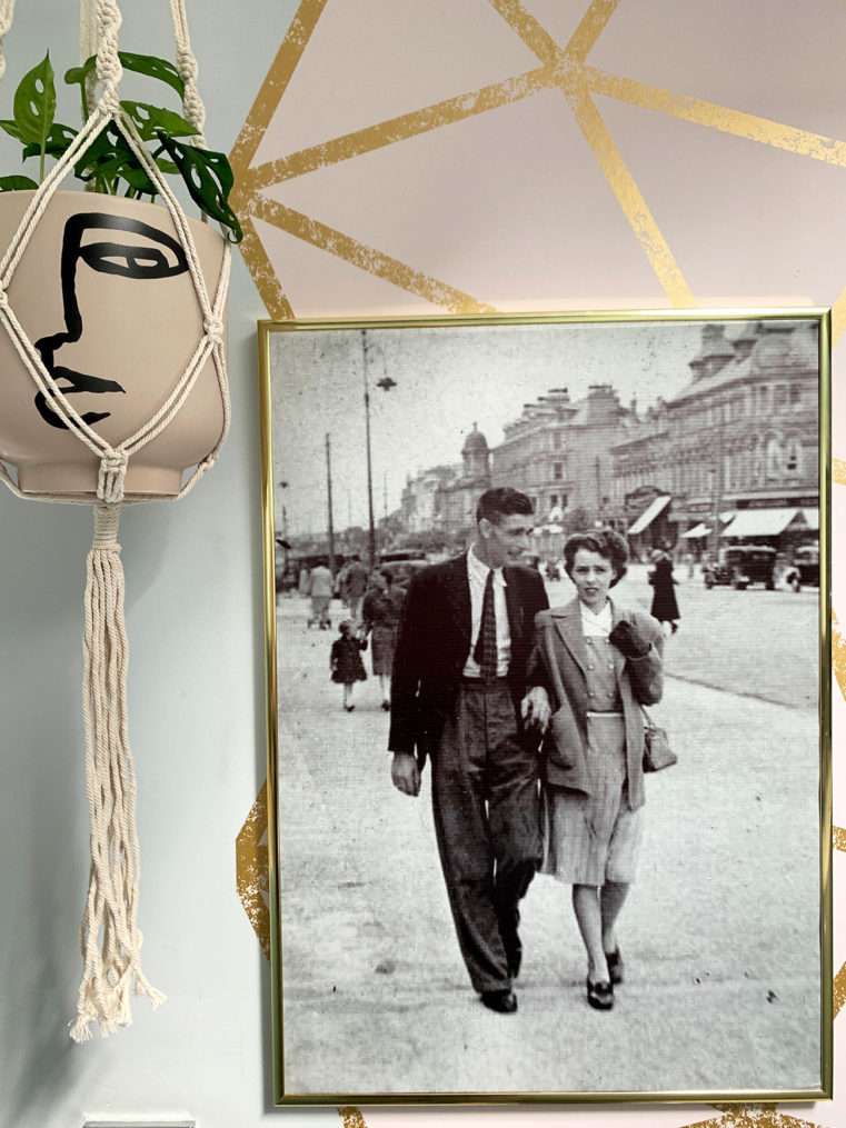 1940's photo of couple in Blackpool on wall next to face hanging planter.