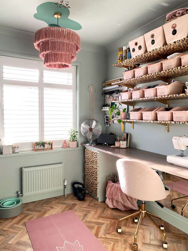Worktop and shelves with craft storage boxes decorated in a soft green blush, and leopard print.