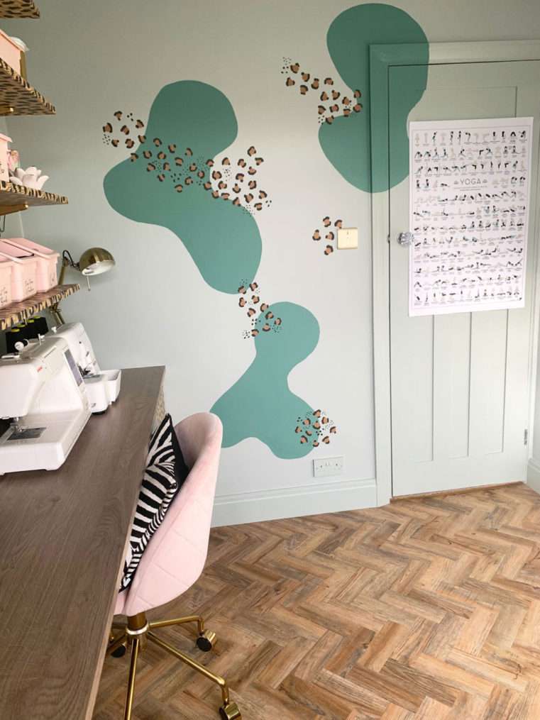 How to create a multi-function room. Door painted in soft green to match with wall and painted mural. Half craft area, and half yoga area.