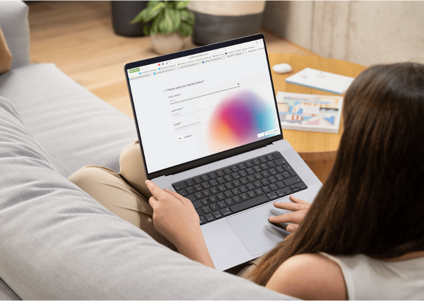 woman on laptop completing a questionnaire