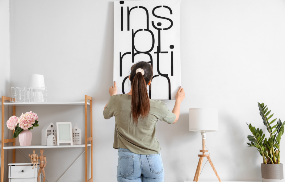 Woman hanging picture