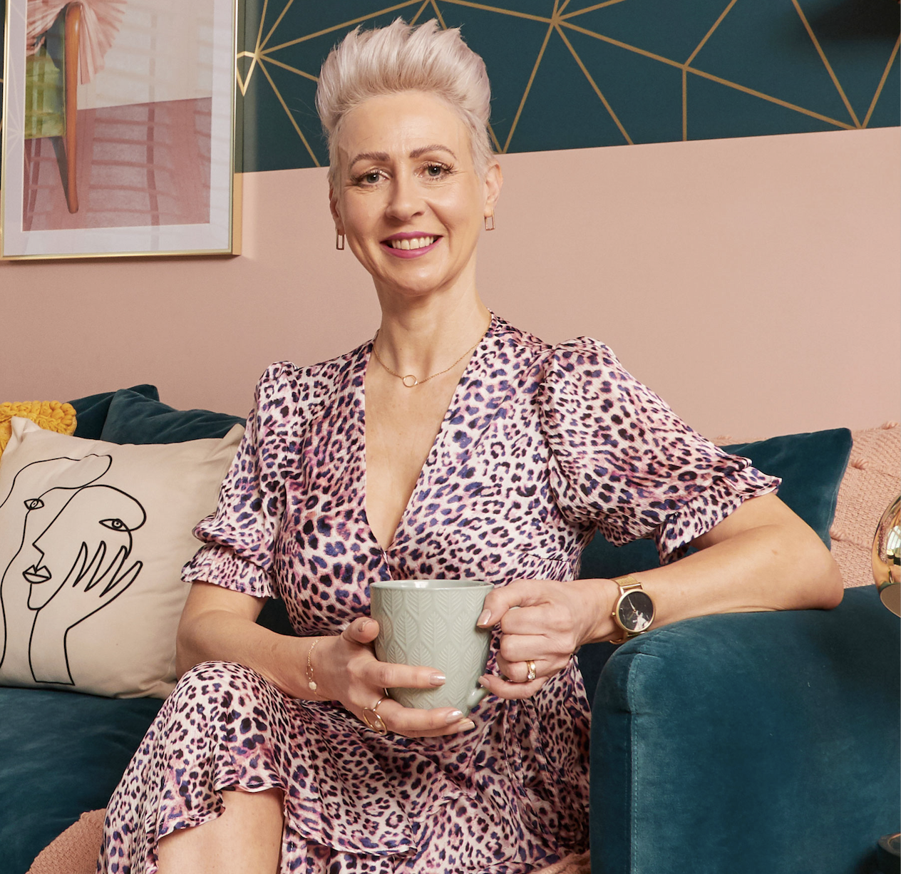 Cara sitting with cup of tea woman with mug of tea, sitting on teal sofa